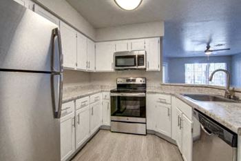 White kitchen cabinetry with stainless steel appliances